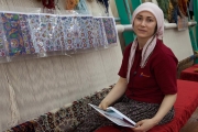 rug weaver holding her portrait from a previous visit, Avanos